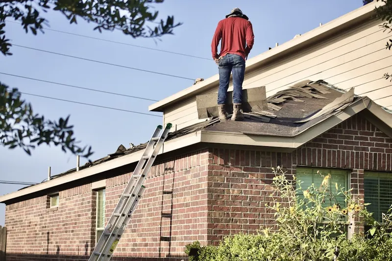 Professional roofer working on a residential roof in Wyoming